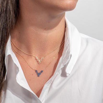 Woman wearing gold-plated 925 sterling silver openwork necklaces with clear and blue zircon stones