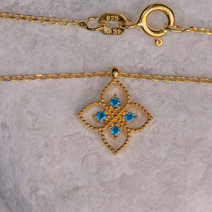Gold-plated 925 sterling silver pendant necklace with flower-shaped motif and four blue zircon stones