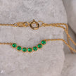 Gold-plated 925 sterling silver chain necklace with central motif of seven green zircon stones in linear arrangement