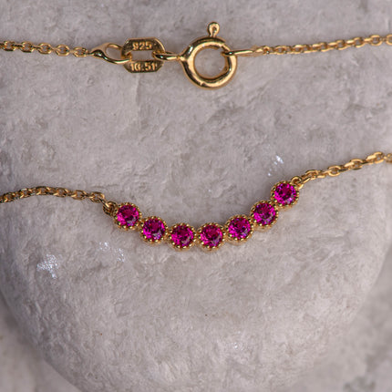 Gold-plated 925 sterling silver chain necklace with central motif of seven pink zircon stones in a modern line