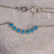 925 sterling silver chain necklace with central motif of seven blue zircon stones in geometric line