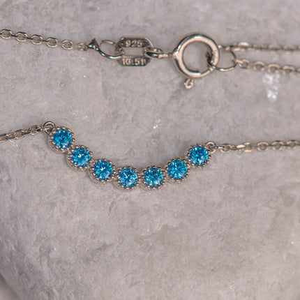 925 sterling silver chain necklace with central motif of seven blue zircon stones in geometric line