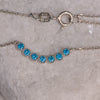 925 sterling silver chain necklace with central motif of seven blue zircon stones in geometric line