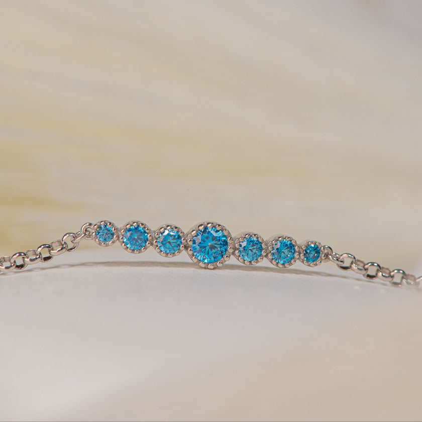 925 sterling silver chain bracelet with graduated central motif of blue zircon stones