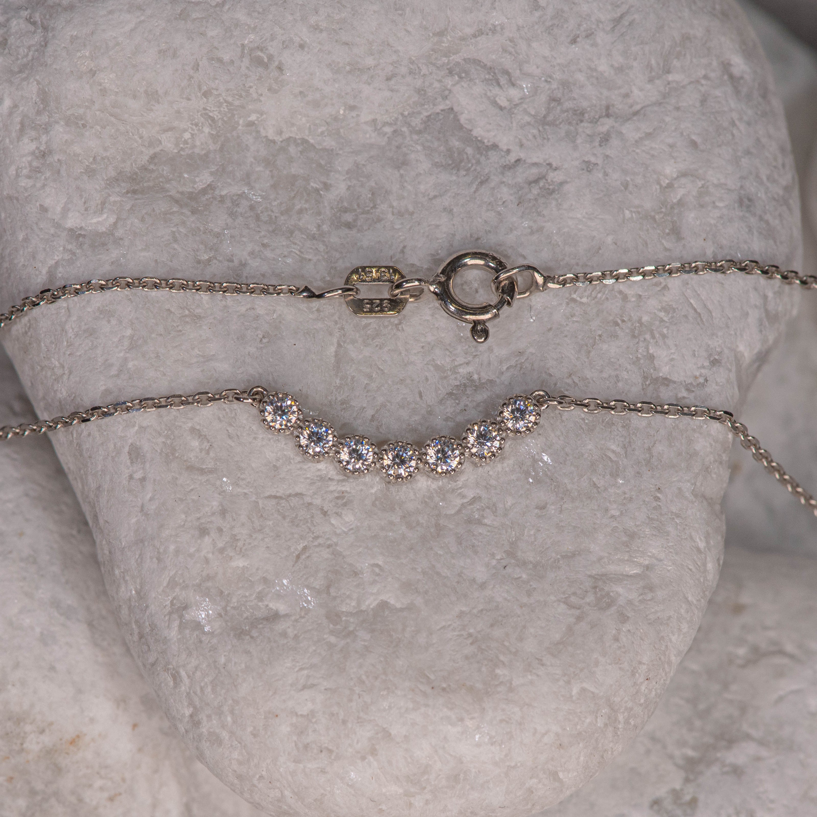 925 sterling silver chain necklace with central motif of seven clear zircon stones in clean line
