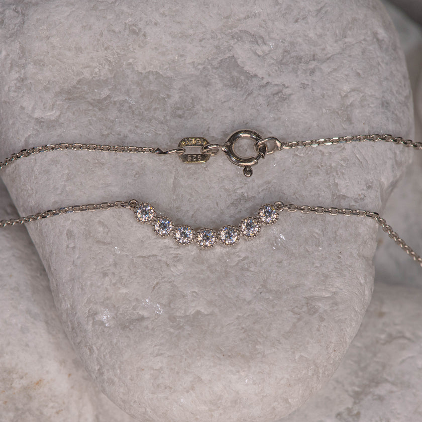 925 sterling silver chain necklace with central motif of seven clear zircon stones in clean line